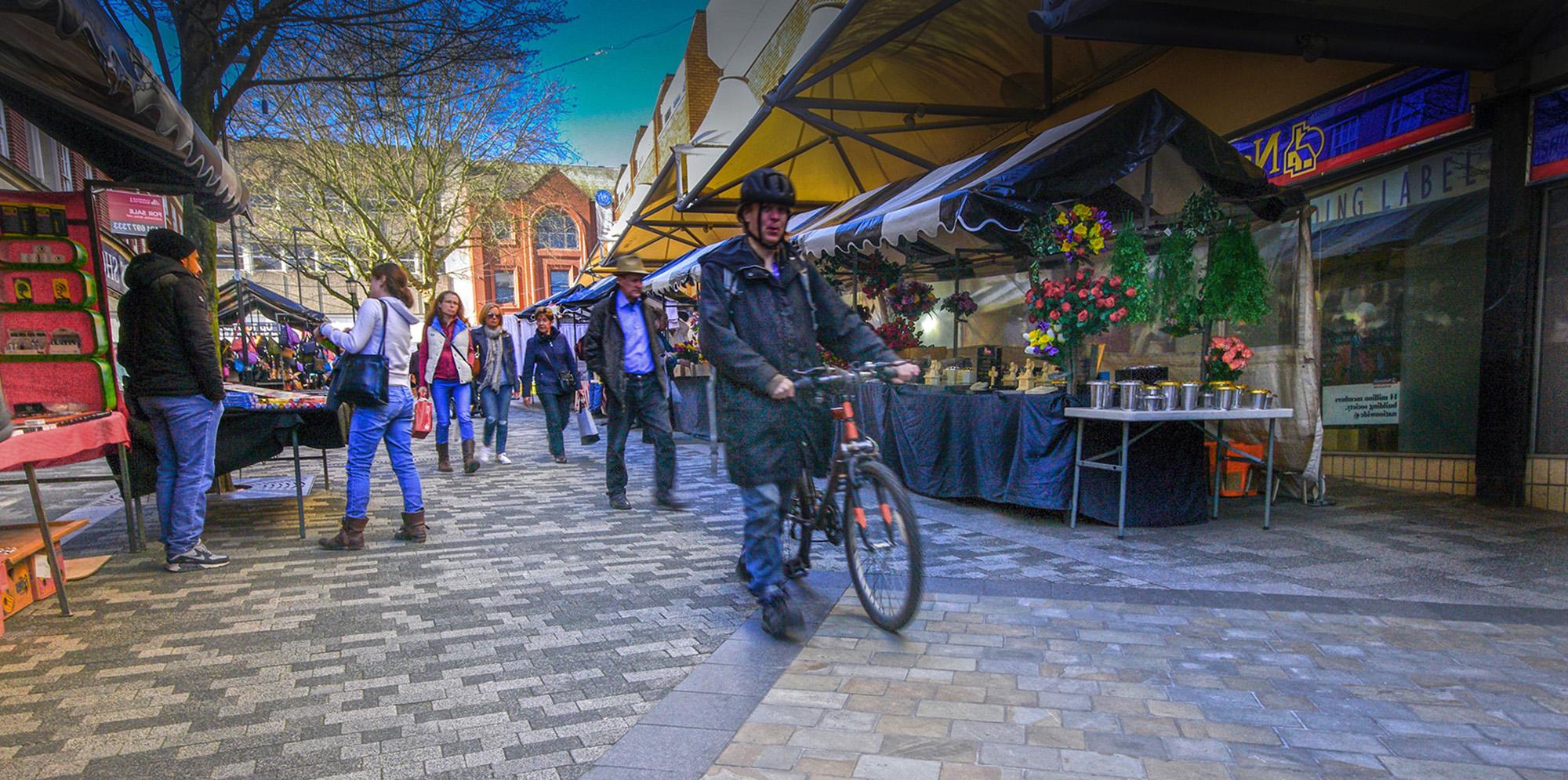 People walking through market at Exchange Place town centre